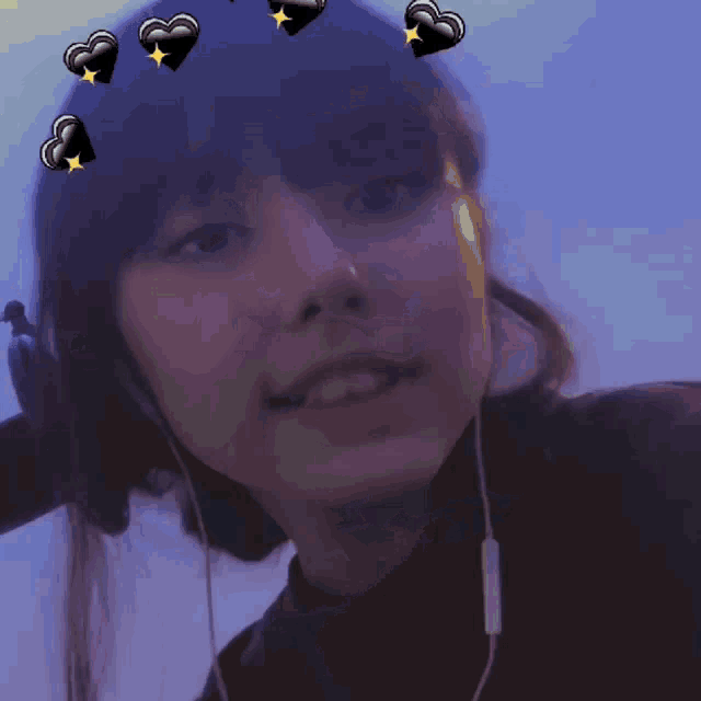 a girl wearing headphones has hearts on her hair