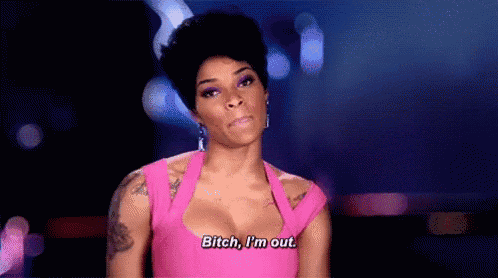 a woman in a pink dress is saying `` bitch , i 'm out '' on a stage .