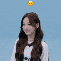 a girl with a smiley face on her head is smiling