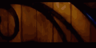 a close up of a wooden wall with a blurred image of a person standing in front of it .