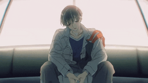 a man sitting on a couch with his head down