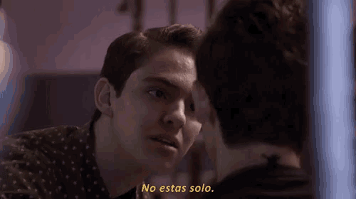 two men are looking at each other with the words no estas solo written in yellow