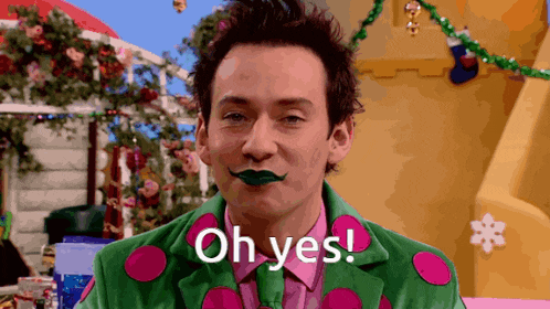 a man in a green and pink suit with polka dots on it says oh yes