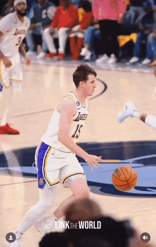 a basketball player with the number 15 on his jersey is dribbling the ball
