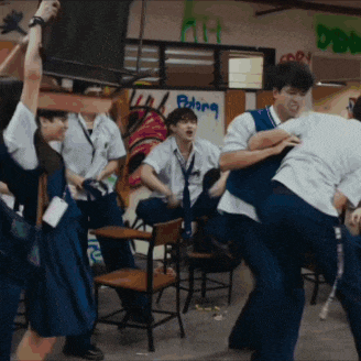 a group of students are having a fight in a room with a sign that says patong
