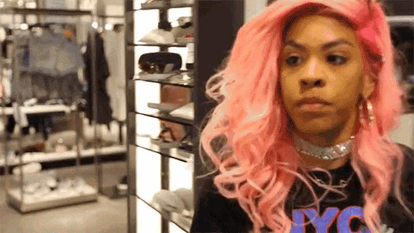 a woman with pink hair and a nyc shirt