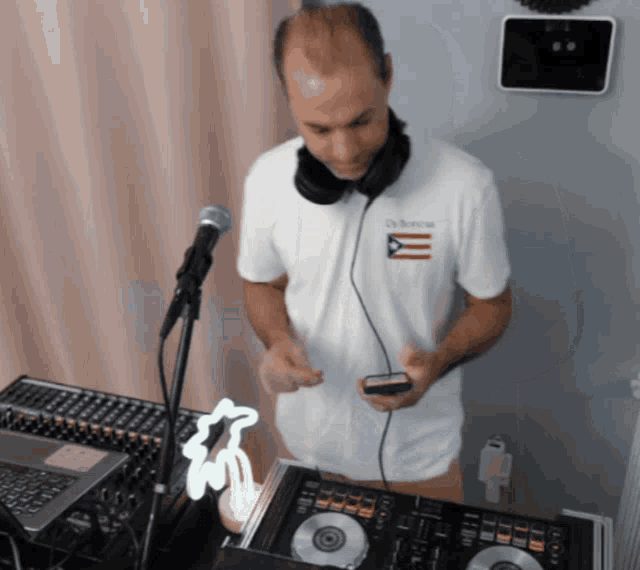 a man wearing headphones and a white shirt that says dr. enrique