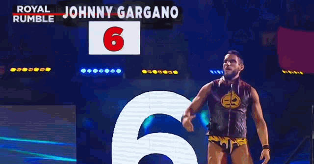 a wrestler is standing in front of a large number 6