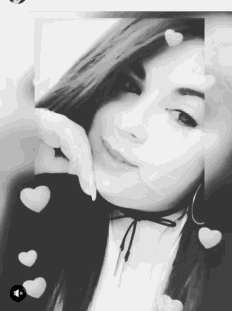 a black and white photo of a woman with white hearts on her head