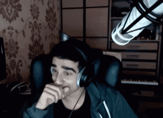 a man is wearing headphones and sitting in front of a microphone .