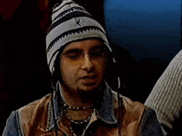 a man wearing a hat and glasses has the name chris kirkpatrick on the screen