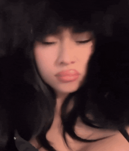 a close up of a woman wearing a fur hat making a funny face .