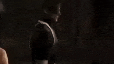 a woman is being attacked by a man in a room .