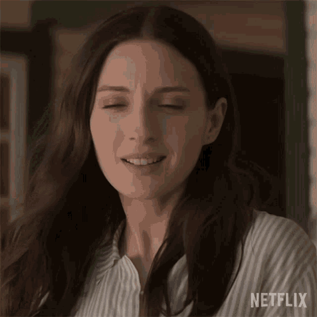 a close up of a woman 's face with her eyes closed and a netflix logo in the corner .
