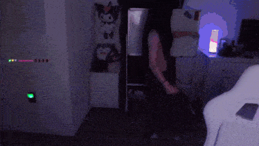 a person is dancing in a dark room with a purple light