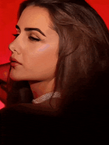 a close up of a woman 's face wearing a choker