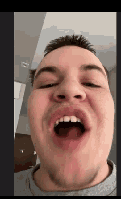 a man making a funny face with his mouth wide open