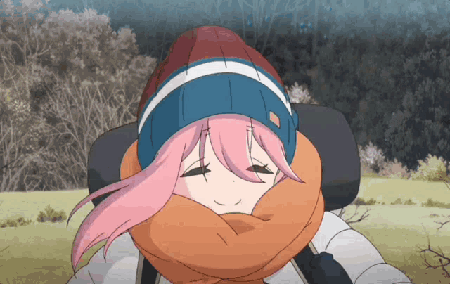 a girl with pink hair and a scarf around her neck is smiling