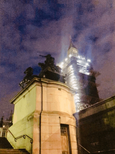 a building with stairs leading up to it and smoke coming out of it