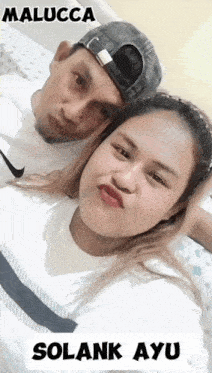 a man and a woman are posing for a picture and the woman is wearing a white nike shirt