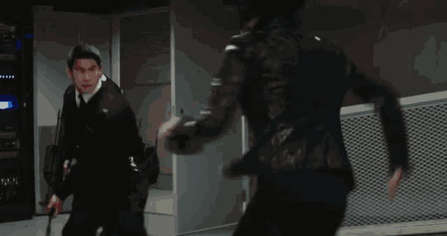 an aerial view of a group of men fighting with guns in a room .