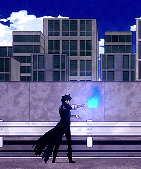 a man in a black cape is standing in front of a building