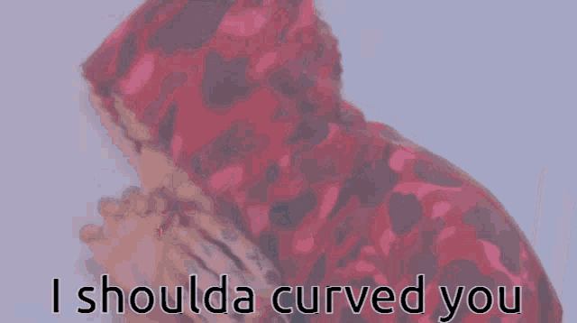 a man in a red hoodie with the words i shoulda curved you on the bottom