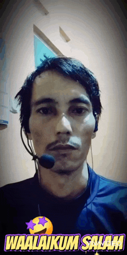 a man wearing headphones and a microphone says waalakum salam