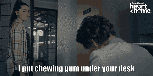 a super channel advertisement for heart & home shows a man chewing gum under his desk