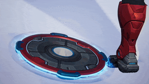 a person 's foot is standing on a red and blue circular object