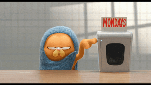 garfield is wrapped in a towel and pointing at a washing machine that says mondays