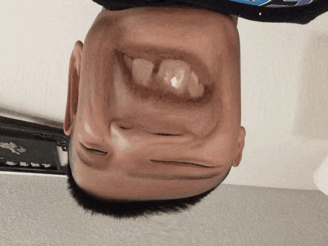 a man 's head is upside down and looks like a cartoon character