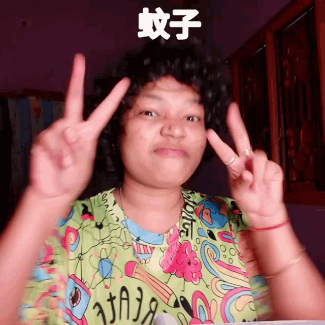a woman wearing a green shirt with chinese writing on it gives the peace sign