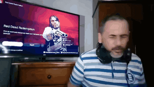 a man is playing red dead redemption on a tv