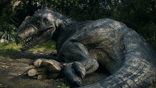 a large dinosaur is laying down in the grass