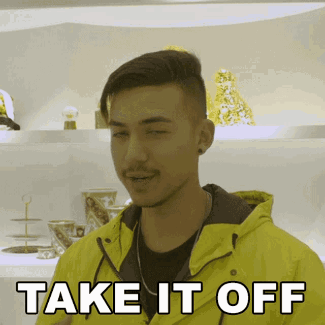 a young man wearing a yellow jacket says take it off