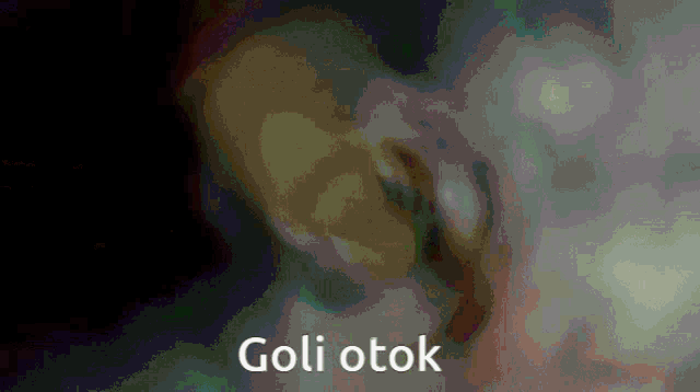 a close up of a person 's ear with the words goli otok written on the bottom