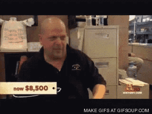 a man in a black shirt stands in front of a sign that says $ 8,500