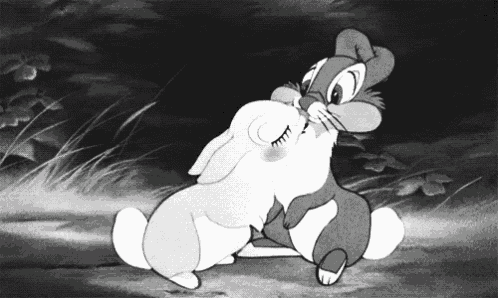 a black and white cartoon of two rabbits kissing each other