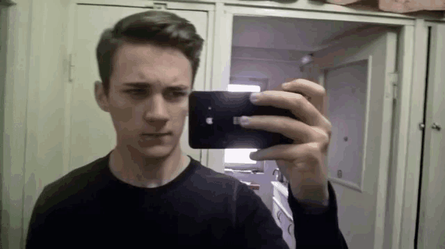 a man is taking a picture of himself in a mirror