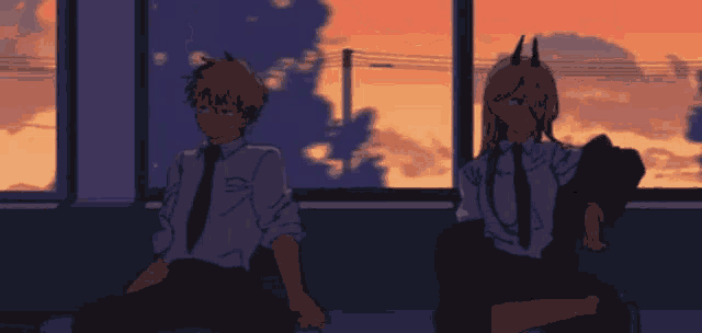 a man and a woman are sitting next to each other in front of a window .