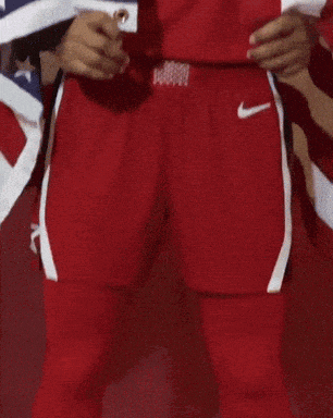 a person wearing a red jersey with the number 14 holding an american flag