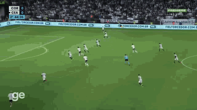 a soccer game is being played on a field with advertisements for fieltorcedor.com.br