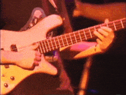a close up of a person playing a guitar on stage