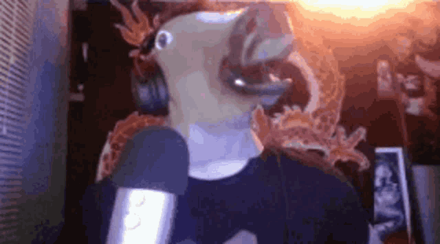 a man wearing a horse mask and headphones stands in front of a microphone