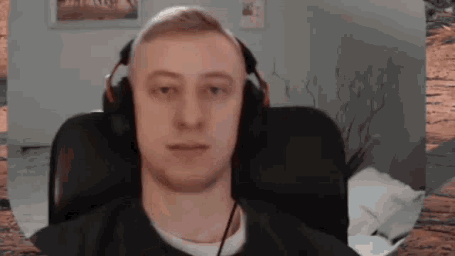 a man wearing headphones sitting in a chair