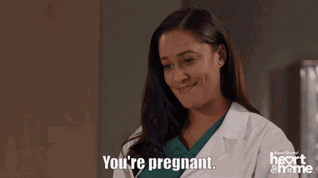 a woman says you 're pregnant in front of a super channel ad