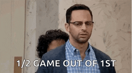 two men are standing next to each other and one of them is talking about a game out of 1st .