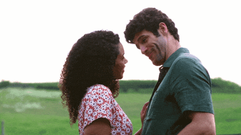 a man and a woman are looking at each other