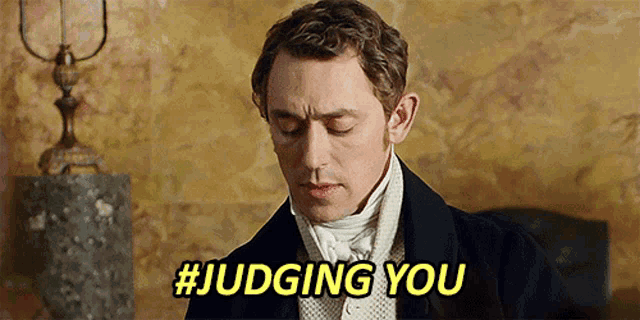 a man in a suit says #judging you in yellow letters